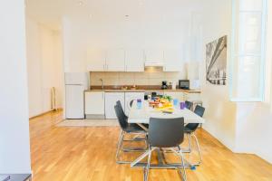 a kitchen with a white table and chairs at CARRE D'OR TERRACE AP4015 NICE by Riviera Holiday Homes in Nice