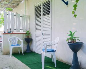 un patio con 2 sillas y una mesa en Casaulente Mare, en Alcamo Marina