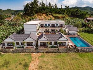 an aerial view of a house with a swimming pool at Karst Villas Phong Nha in Phong Nha