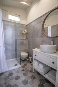 a bathroom with a sink and a shower and a toilet at Levkosh Apartments at Lefkada's Heart in Lefkada