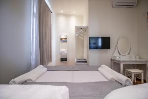 A bed or beds in a room at Levkosh Apartments at Lefkada's Heart