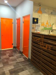 a row of orange doors in a room at Light Life Hostel in Kyiv