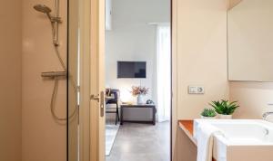 a bathroom with a shower and a sink and a desk at Casa Marcial (adults only) in Besalú