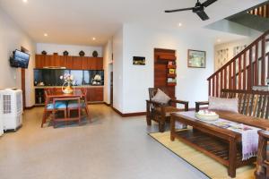 a living room with a table and a dining room at Golden Vishnu Villa in Siem Reap