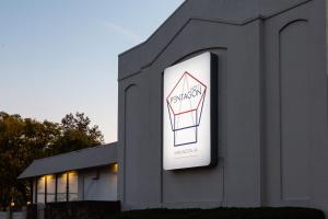 a building with a sign on the side of it at Hotel Pentagon in Arlington