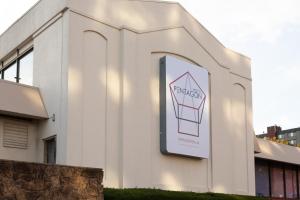 a white building with a sign on the side of it at Hotel Pentagon in Arlington