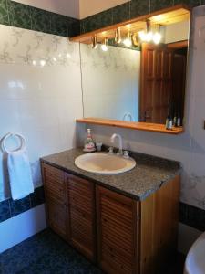a bathroom with a sink and a mirror at Casa Vacanze Arenella in Arenella