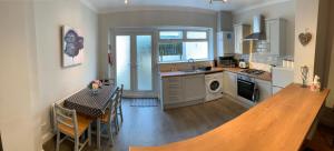 a kitchen with a table and a dining room at Durham 3 Bedroom House With Parking in Durham