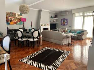 a living room with a couch and a table at chalet villa inside Madrid in Madrid