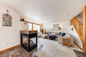a living room with a fireplace and a couch at Beachcomber's Paradise in Pacific City