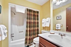 a bathroom with a sink and a toilet and a shower at Cleerwood Village #252 in Eagle River +29 photos