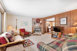 a living room with a couch and a television at Cleerwood Village #252 in Eagle River