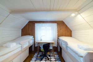 a room with two beds and a table in it at DOMEK NAD WISŁĄ in Kazimierz Dolny