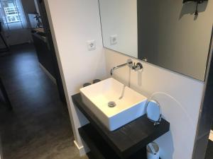 a bathroom with a sink and a mirror at Pakhuis 5 in Katwijk aan Zee +41 photos