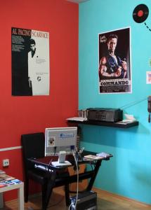 an office with a desk with a computer and posters at Ruta 80 Hostel in Brno