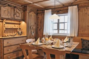 a dining room with a table and a window at Wald 12 Ferienhaus in Wald am Arlberg