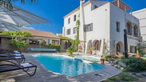a swimming pool in front of a house at Laniella location in Calvi