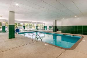 a large swimming pool with blue water in a building at Comfort Inn & Suites Nashville Franklin Cool Springs in Franklin