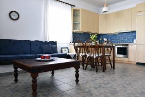 a kitchen and dining room with a table and chairs at The Stone Beach House in the area of Kampi, Koundouros in Ioulis