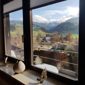 a window with a view of a mountain at Haus Hochgrat in Oberstaufen +7 photos