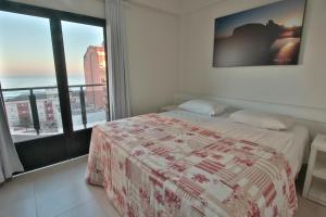 a bedroom with a bed and a view of the ocean at Life Hotel Torres in Torres +45 photos