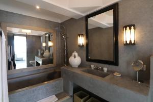 a bathroom with a sink and a large mirror at Dar Seven in Marrakesh