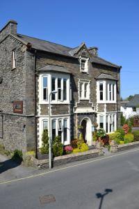 an old stone house on the side of a street at Jerichos Boutique Accommodation in Windermere
