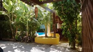 a patio with plants and a swimming pool at Apart Hotel Casa Grande in Natal