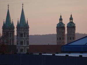 a group of tall buildings with crosses on their towers at Ferienwohnung Familie Bulst in Naumburg