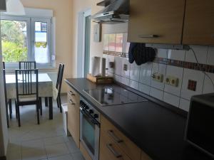 a kitchen with a stove top oven next to a table at Ferienwohnung Familie Bulst in Naumburg