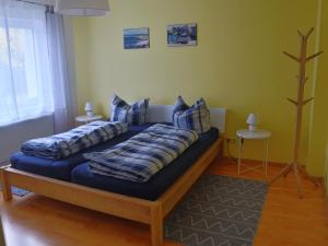 a bedroom with a bed with blue pillows at Ferienwohnung Familie Bulst in Naumburg