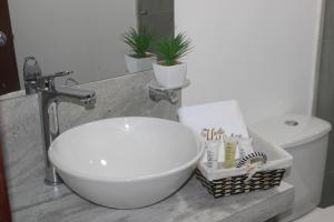 a bathroom with a sink and a toilet at Casa La Huerta in Tibasosa +28 photos