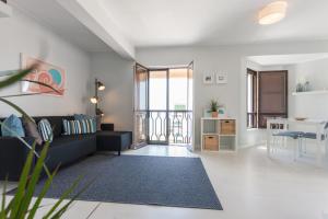 a living room with a couch and a table at FLH - Ericeira Beach Apartments in Ericeira