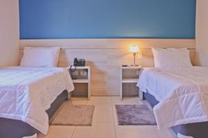 Uma cama ou camas num quarto em Nova Hotel