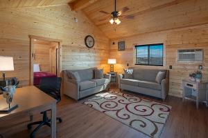 a living room with two couches and a table at Cabins at Grand Canyon West in Peach Springs