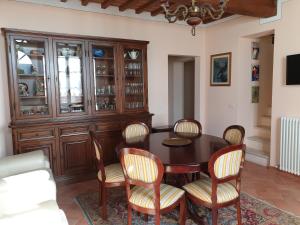 a dining room with a table and chairs at Podere il Poggio in Asciano