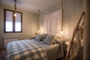 a bedroom with a bed with a checkered blanket at La Casita de Candela Toledo in Toledo