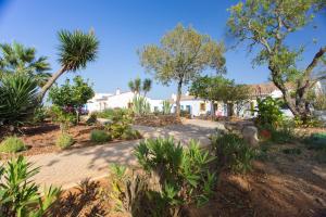 a house in the middle of a yard with trees at Casas da Capela do Monte, Country Houses in Lagos