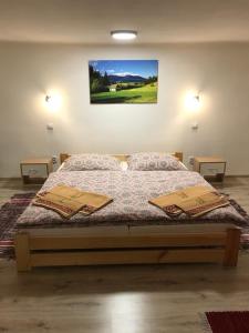 a bedroom with a bed with two pillows on it at Apartmán Jedlička in Telgárt