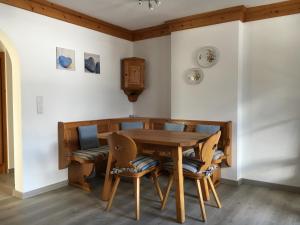 a dining room with a wooden table and chairs at Landhaus Holzereck in Ehrwald