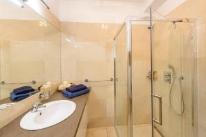 a bathroom with a sink and a shower at Chopok juh Apartman Vanda in Tale