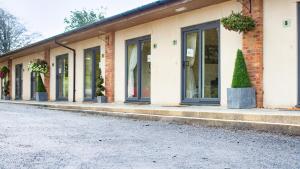a row of windows on a building with potted plants at Accommodation Bristol Airport in Redhill