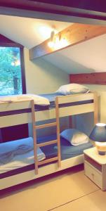 two bunk beds in a room with a window at Wood House in Blaimont