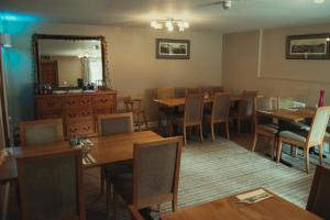 a dining room with tables and chairs and a mirror at The Kings Head in New Buckenham