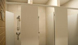 a shower with a glass door in a bathroom at Marco Polo Party Hostel in St. Julianʼs