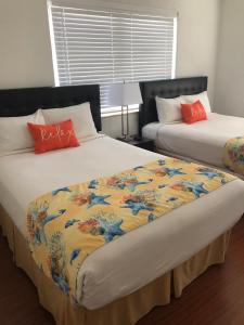 Postel nebo postele na pokoji v ubytování Beach Place Hotel