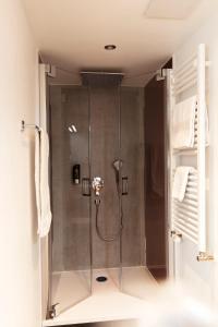 a shower with a glass door in a bathroom at Hotel Restaurant Zum Hirschen in Donaueschingen