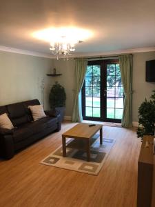a living room with a couch and a coffee table at Little Hermitage in Detling