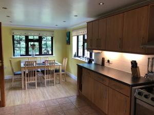 a kitchen with a table and a dining room at Little Hermitage in Detling