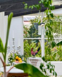 a window with a rooster decoration on it at Boscobel of Tasmania in Ulverstone